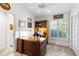 Bright office featuring a large desk, wood flooring, and a window with shutters at 4701 Pine Harrier Dr, Sarasota, FL 34231