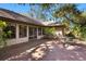 Inviting brick patio with outdoor seating, accessible via glass doors, perfect for enjoying the serene backyard at 4701 Pine Harrier Dr, Sarasota, FL 34231