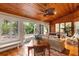 Relaxing sunroom with tile floors, wood ceilings and walls of windows to view patio at 4701 Pine Harrier Dr, Sarasota, FL 34231