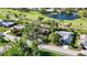 Bird's-eye view of a neighborhood near the golf course and pond, showcasing the house and surroundings at 4965 Marsh Field Rd, Sarasota, FL 34235