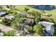 High-angle shot of a residence with its screened lanais, nestled near a golf course and pond at 4965 Marsh Field Rd, Sarasota, FL 34235