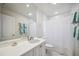 Bright bathroom with white fixtures, a large mirror, and coordinated teal towels at 4965 Marsh Field Rd, Sarasota, FL 34235