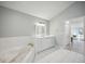 Bright bathroom with a soaking tub, neutral walls, and a large vanity at 4965 Marsh Field Rd, Sarasota, FL 34235