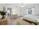 Well-lit bedroom featuring a cozy bed, functional desk, and view into the home at 4965 Marsh Field Rd, Sarasota, FL 34235