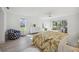 Light-filled bedroom featuring modern furnishings, a floral bedspread, and sliding glass doors at 4965 Marsh Field Rd, Sarasota, FL 34235