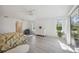Spacious bedroom with natural light, light wood flooring, floral bedding and backyard views at 4965 Marsh Field Rd, Sarasota, FL 34235