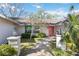 Charming front entrance with brick walkway, updated lighting, and colorful door at 4965 Marsh Field Rd, Sarasota, FL 34235