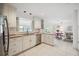 Bright, clean kitchen with white cabinets, stainless dishwasher and a view to the breakfast nook at 4965 Marsh Field Rd, Sarasota, FL 34235