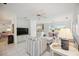 Bright living room with white tile floors, comfortable seating, and an open layout to the kitchen and dining area at 4965 Marsh Field Rd, Sarasota, FL 34235