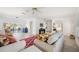 Inviting living room with abundant seating, sleek floors, ceiling fan, and open access to a dining area at 4965 Marsh Field Rd, Sarasota, FL 34235