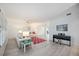 Bright living room with sleek floors, piano, white furniture, and shuttered windows for natural light at 4965 Marsh Field Rd, Sarasota, FL 34235