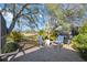 Charming backyard patio featuring a grill and seating with view of lush greenery at 4965 Marsh Field Rd, Sarasota, FL 34235