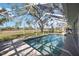 Outdoor pool features screen enclosure, brick paved deck, and view of the golf course at 4965 Marsh Field Rd, Sarasota, FL 34235