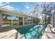 Outdoor pool area enclosed with screen and view of the golf course at 4965 Marsh Field Rd, Sarasota, FL 34235