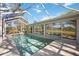 Inviting screened in pool area features paved deck and neighborhood views at 4965 Marsh Field Rd, Sarasota, FL 34235