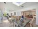 Bright sunroom featuring a glass table, comfortable wicker furniture and access to the backyard at 4965 Marsh Field Rd, Sarasota, FL 34235