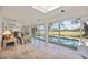 Lovely sunroom featuring tiled floor, skylight and view of the pool and backyard at 4965 Marsh Field Rd, Sarasota, FL 34235