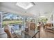 Sunroom featuring a glass table, comfortable wicker furniture, and an abundance of natural light at 4965 Marsh Field Rd, Sarasota, FL 34235