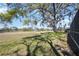 Expansive green yard with mature trees and a partial view of the golf course at 4965 Marsh Field Rd, Sarasota, FL 34235