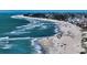 Expansive beach scene showing the beach, ocean, and a distant view of the city and its houses at 5007 2Nd Ave, Holmes Beach, FL 34217