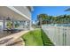 Inviting backyard with artificial grass, a lounge area, privacy fence, and a glimpse of the pool at 5007 2Nd Ave, Holmes Beach, FL 34217
