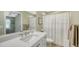 Bathroom featuring quartz countertop, modern sink faucet, and framed mirror with accent lighting at 5007 2Nd Ave, Holmes Beach, FL 34217