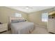 Well-lit bedroom with neutral decor, a dresser, carpet, and ample natural light from windows at 5007 2Nd Ave, Holmes Beach, FL 34217