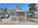 Charming coastal home with a white fence, upper deck, two-car garage and a brick paver driveway at 5007 2Nd Ave, Holmes Beach, FL 34217
