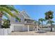 Beautiful two-story home featuring a quaint balcony, an exterior staircase, and a brick paver driveway at 5007 2Nd Ave, Holmes Beach, FL 34217