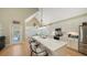 Well-lit open kitchen with a large island, bar seating, and stainless steel appliances at 5007 2Nd Ave, Holmes Beach, FL 34217