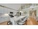 Modern kitchen with white cabinets, quartz countertops, stainless steel appliances, and a breakfast bar with seating at 5007 2Nd Ave, Holmes Beach, FL 34217