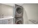 Modern laundry room with stacked washer and dryer, and white quartz countertop at 5007 2Nd Ave, Holmes Beach, FL 34217