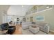 Bright and airy open-concept space featuring a living room, kitchen, and dining area with vaulted ceilings at 5007 2Nd Ave, Holmes Beach, FL 34217