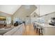 Open-concept living space with a vaulted ceiling, a comfortable seating area, and a modern kitchen with a breakfast bar at 5007 2Nd Ave, Holmes Beach, FL 34217