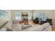 Airy living room showcasing a comfortable sectional sofa, two recliners, and large windows with blinds at 5007 2Nd Ave, Holmes Beach, FL 34217