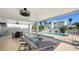 Inviting covered patio with pool access, featuring lounge chairs and an outdoor dining set at 5007 2Nd Ave, Holmes Beach, FL 34217