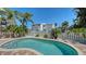 Backyard pool surrounded by lush landscaping and a white privacy fence, creating a private oasis at 5007 2Nd Ave, Holmes Beach, FL 34217