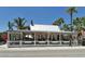 Outdoor dining area view with a yellow exterior building under a striped canopy at 5007 2Nd Ave, Holmes Beach, FL 34217