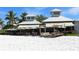 Beachside restaurant with patio seating and umbrellas offering views of the sandy shore at 5007 2Nd Ave, Holmes Beach, FL 34217