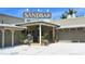 Sandbar restaurant entrance with outside seating and lush greenery on a sunny day at 5007 2Nd Ave, Holmes Beach, FL 34217