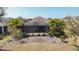 Private backyard features a screened-in lanai surrounded by tropical landscaping at 5011 Kincaid Park Ln, Bradenton, FL 34211