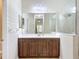 Bathroom vanity with wood cabinets, white countertop, and large mirror at 5011 Kincaid Park Ln, Bradenton, FL 34211