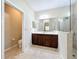 Bathroom features a modern vanity with wood cabinets and a glass-enclosed shower at 5011 Kincaid Park Ln, Bradenton, FL 34211