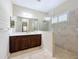 Modern bathroom featuring a glass-enclosed shower and a dark wood vanity with a white countertop at 5011 Kincaid Park Ln, Bradenton, FL 34211