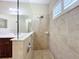 Bathroom shower with beige tile surround, glass partition, and updated fixtures at 5011 Kincaid Park Ln, Bradenton, FL 34211