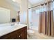 Bathroom featuring a shower-tub combo, vanity with solid surface, and a neutral color palette at 5011 Kincaid Park Ln, Bradenton, FL 34211