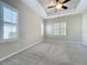 Bright bedroom boasting a trey ceiling, neutral walls and two shuttered windows at 5011 Kincaid Park Ln, Bradenton, FL 34211