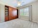 Cozy bedroom featuring neutral walls, a murphy bed and a window with shutter-style blinds at 5011 Kincaid Park Ln, Bradenton, FL 34211