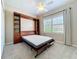Bedroom with a Murphy bed, built-in shelves, and natural light streaming through the window at 5011 Kincaid Park Ln, Bradenton, FL 34211