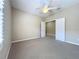 Carpeted bedroom with ceiling fan, neutral walls and white trim, ready for personal touches at 5011 Kincaid Park Ln, Bradenton, FL 34211